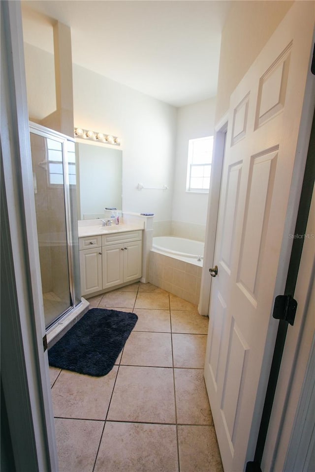 bathroom featuring vanity, tile patterned floors, a garden tub, and a stall shower