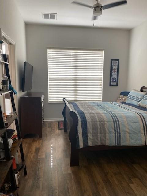 bedroom featuring ceiling fan and dark wood-type flooring