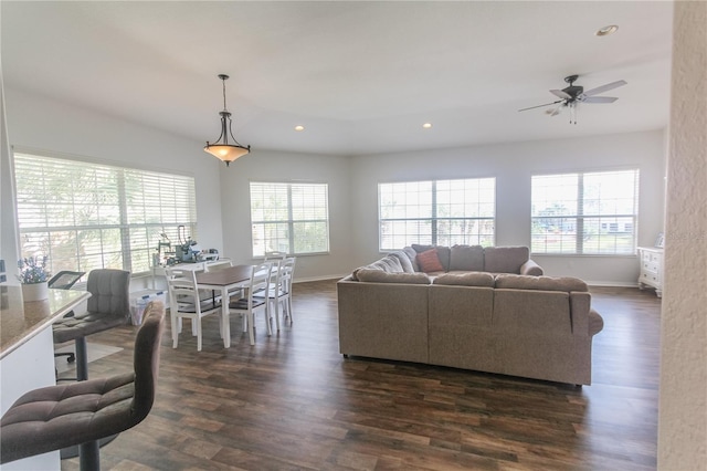 living room featuring ceiling fan and dark hardwood / wood-style flooring