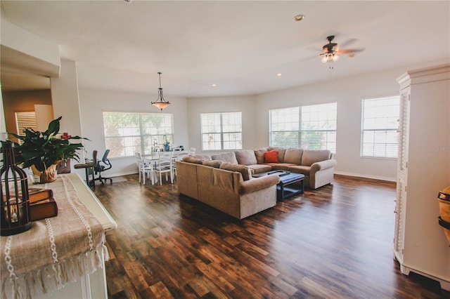 living room featuring dark hardwood / wood-style floors, ceiling fan, and plenty of natural light