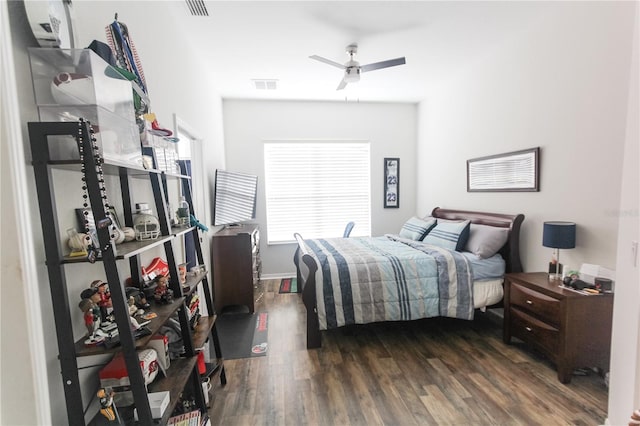 bedroom with dark hardwood / wood-style flooring and ceiling fan