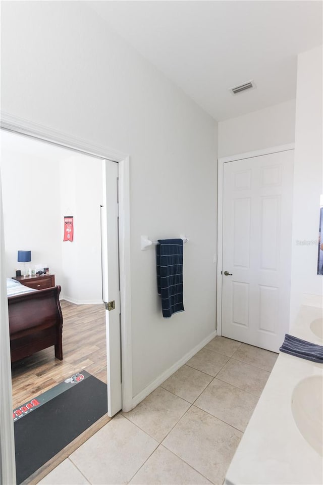 bathroom featuring tile patterned flooring and vanity