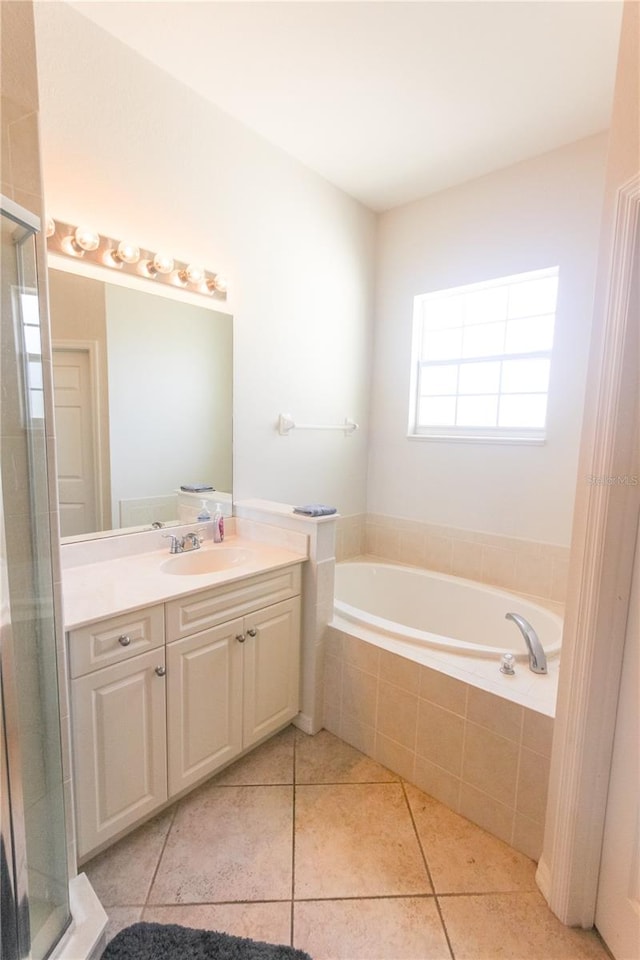 bathroom with tile patterned flooring, shower with separate bathtub, and vanity