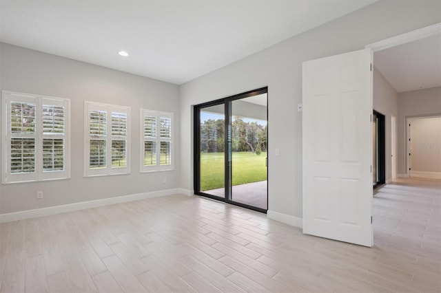 spare room featuring light hardwood / wood-style floors