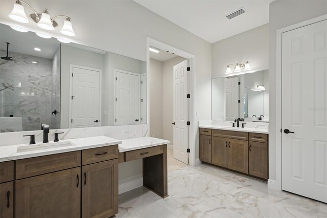 bathroom with vanity and tiled shower