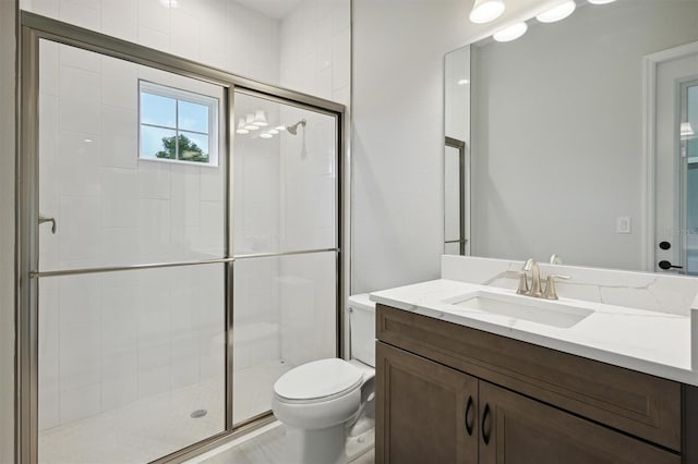 bathroom with vanity, toilet, and an enclosed shower