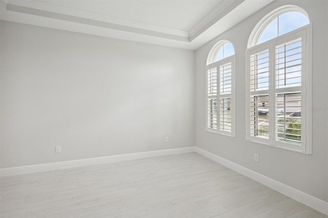 spare room with a healthy amount of sunlight and light hardwood / wood-style flooring