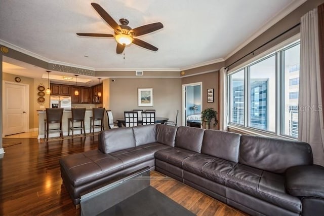 living room with crown molding, ceiling fan, and hardwood / wood-style floors