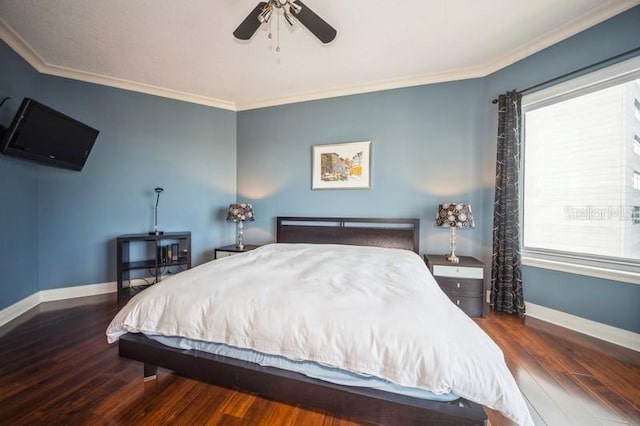 bedroom with dark hardwood / wood-style flooring, ceiling fan, and crown molding