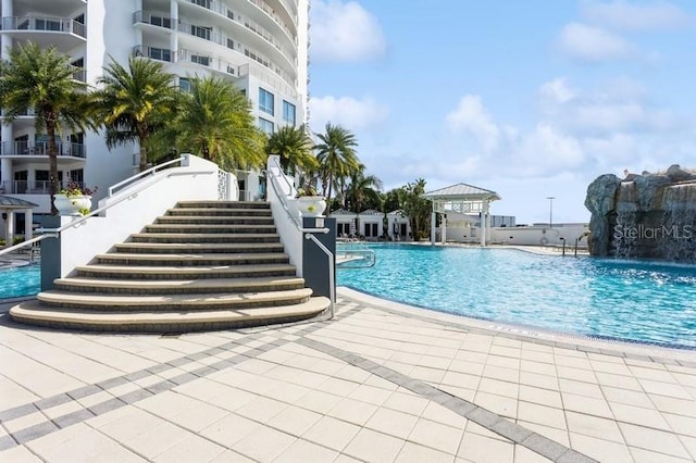 view of swimming pool with pool water feature