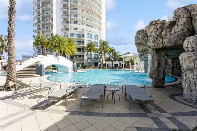 view of pool with a patio and pool water feature