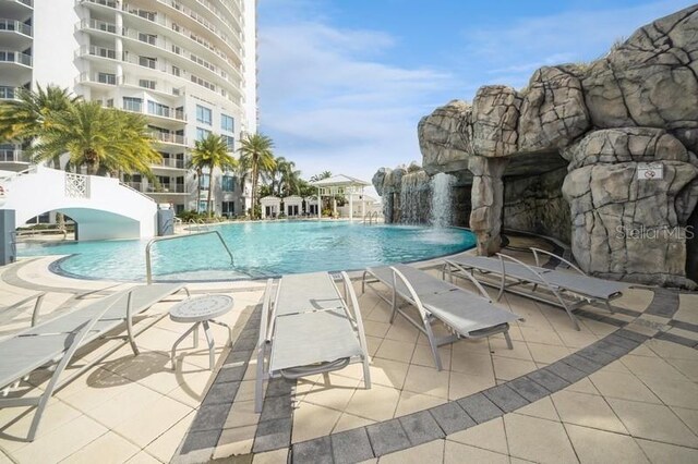 view of swimming pool featuring a patio and pool water feature