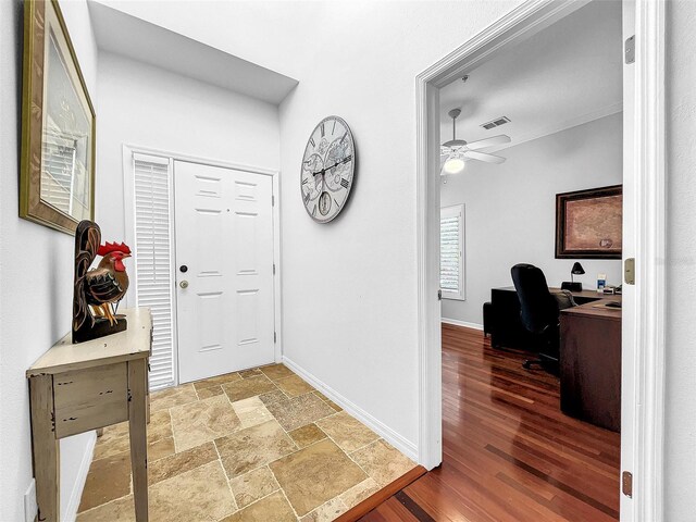 foyer entrance featuring ceiling fan