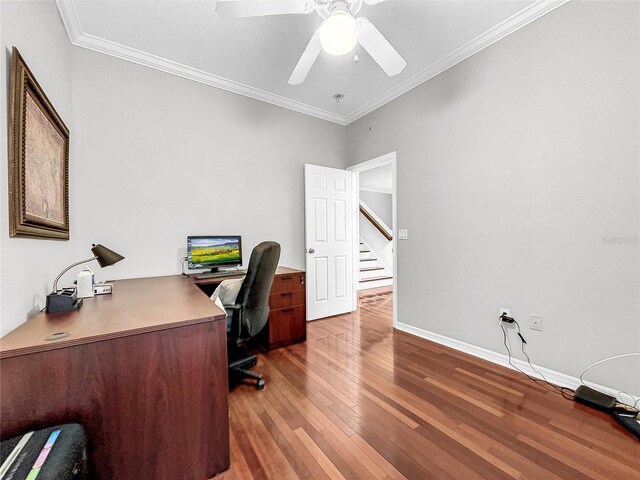 home office with ceiling fan, ornamental molding, and dark wood-type flooring