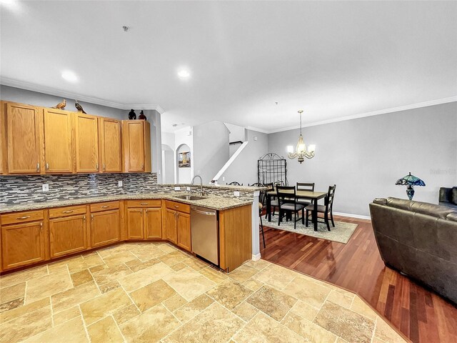 kitchen featuring sink, hanging light fixtures, an inviting chandelier, stainless steel dishwasher, and crown molding