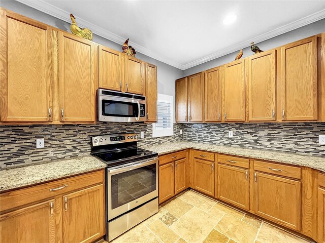 kitchen with tasteful backsplash, crown molding, stainless steel appliances, and light stone counters