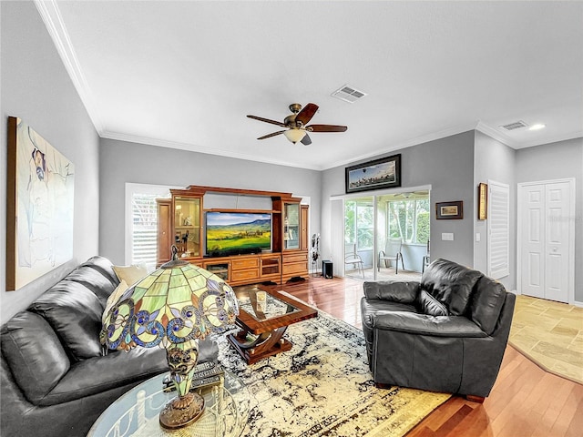 living room featuring light hardwood / wood-style floors, ceiling fan, and ornamental molding