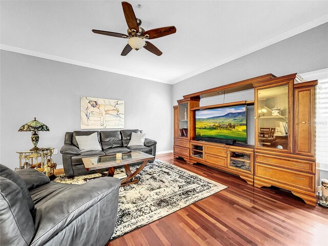 living room with ceiling fan, wood-type flooring, and ornamental molding