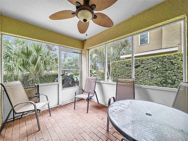 sunroom / solarium featuring ceiling fan and plenty of natural light