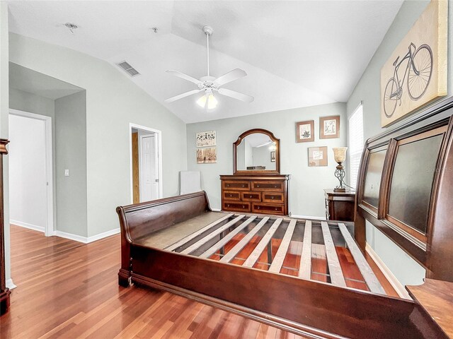 bedroom featuring wood-type flooring, vaulted ceiling, and ceiling fan