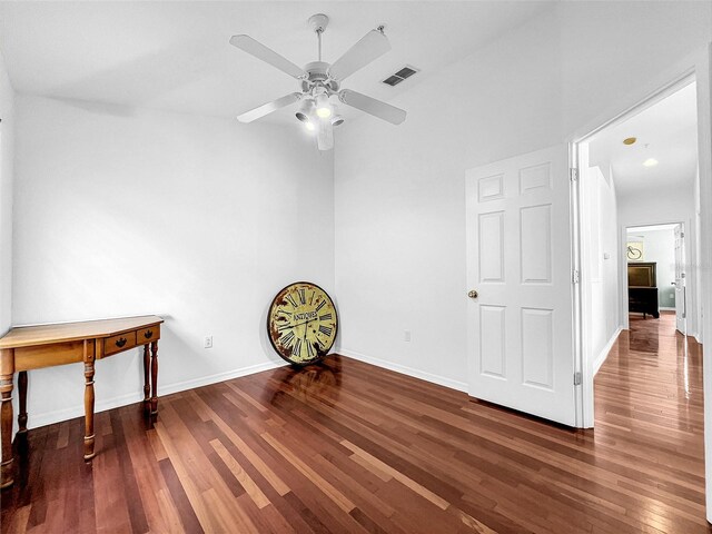 empty room featuring ceiling fan and dark wood-type flooring