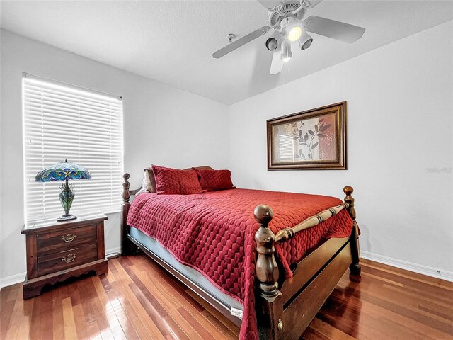 bedroom with hardwood / wood-style flooring and ceiling fan