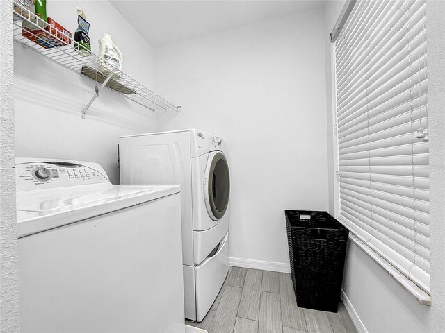 clothes washing area with washing machine and dryer