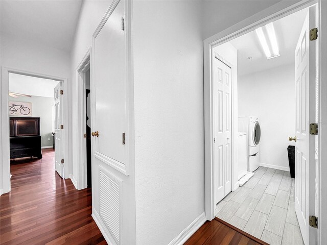 corridor featuring hardwood / wood-style flooring and washer / clothes dryer