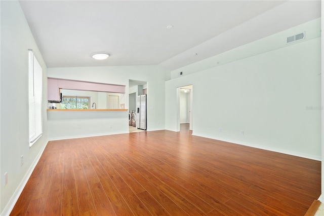 unfurnished living room with light hardwood / wood-style flooring and lofted ceiling