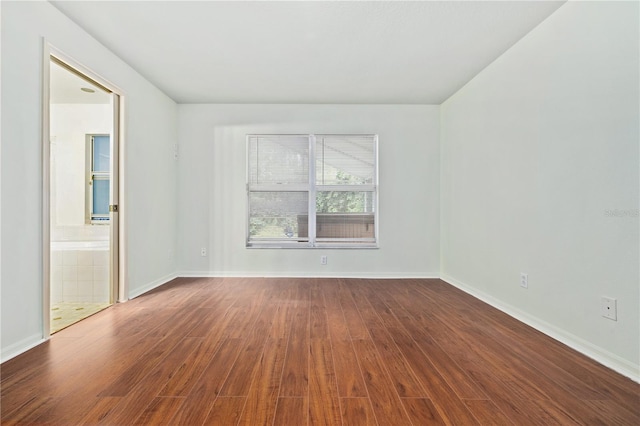 empty room with hardwood / wood-style flooring