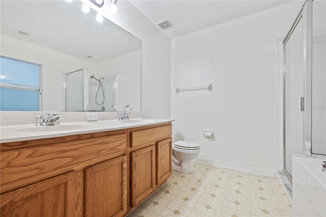 bathroom featuring vanity, an enclosed shower, and toilet