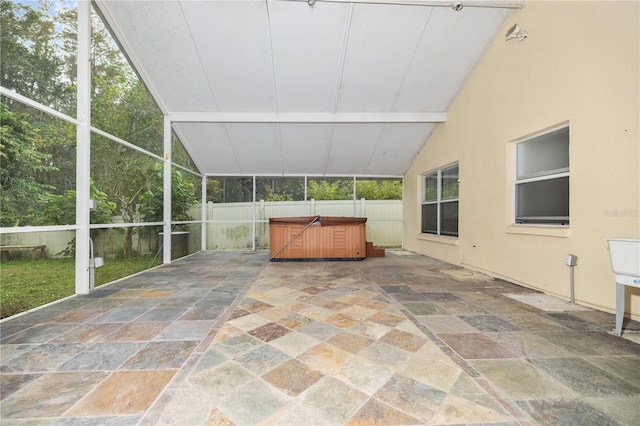 unfurnished sunroom with lofted ceiling with beams