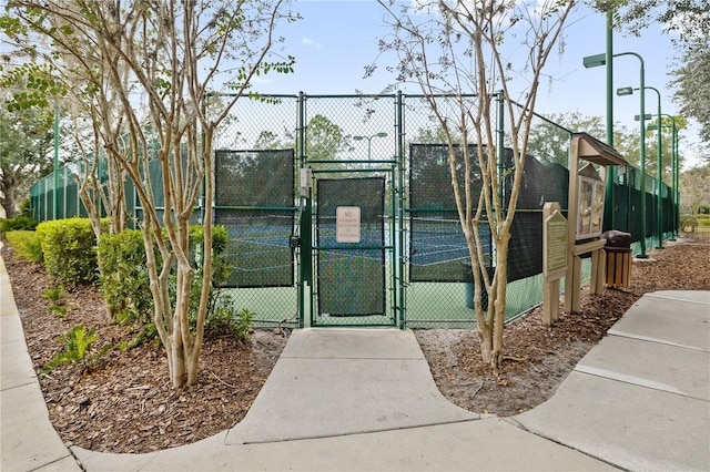 view of property's community featuring tennis court