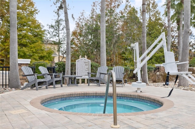 view of pool featuring a patio area and an in ground hot tub