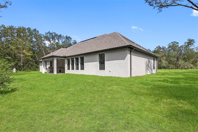 rear view of property featuring a lawn