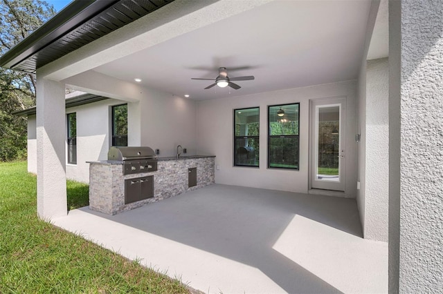 view of patio featuring area for grilling, ceiling fan, sink, and an outdoor kitchen