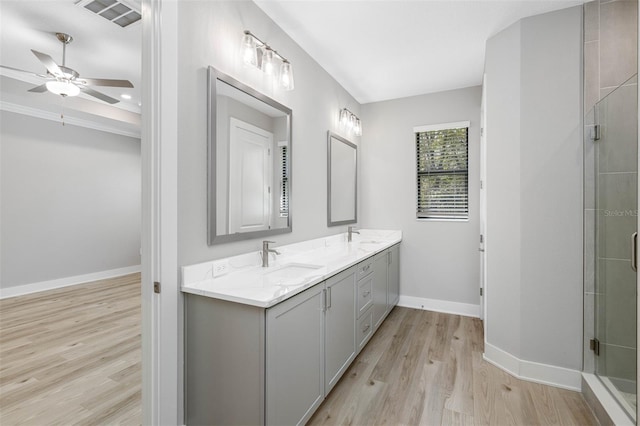 bathroom featuring ceiling fan, a shower with door, vanity, and wood-type flooring