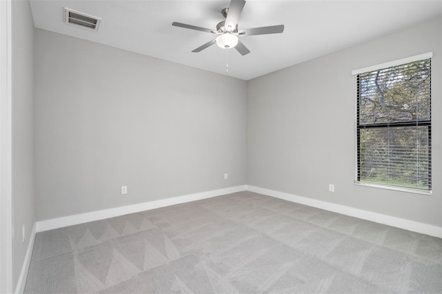 carpeted empty room featuring ceiling fan and a healthy amount of sunlight