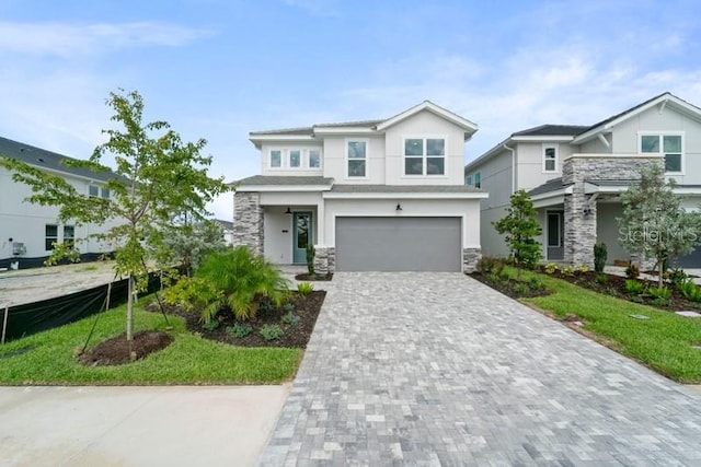 view of front of property featuring a front lawn and a garage