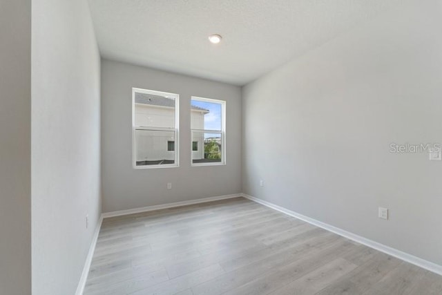 unfurnished room with light hardwood / wood-style floors