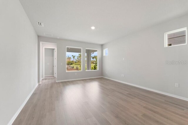 empty room with light hardwood / wood-style flooring