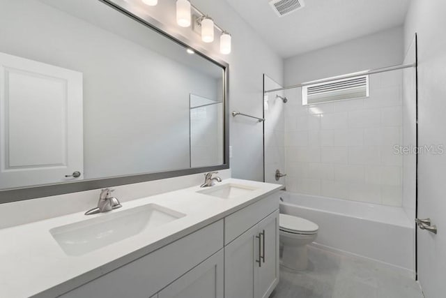 full bathroom featuring vanity, tiled shower / bath combo, and toilet