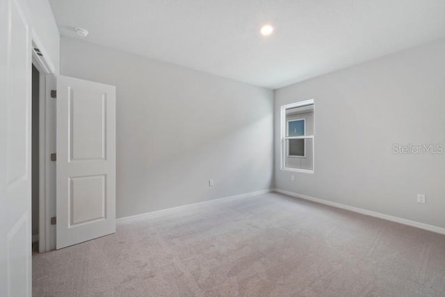 spare room with light colored carpet