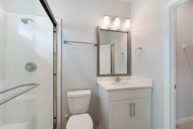 bathroom with vanity, toilet, and an enclosed shower