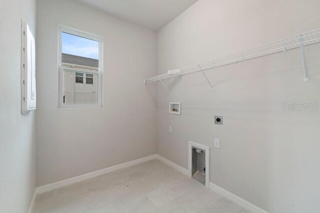 washroom featuring hookup for an electric dryer, hookup for a washing machine, and electric panel