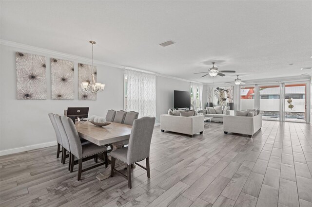 dining room with crown molding, ceiling fan with notable chandelier, and light hardwood / wood-style flooring