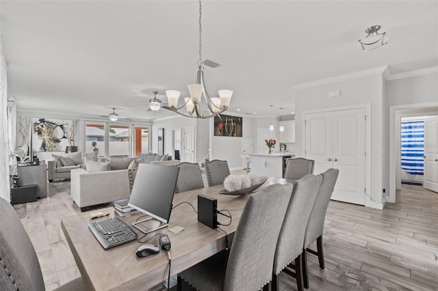 dining area with ceiling fan with notable chandelier, crown molding, and light hardwood / wood-style flooring