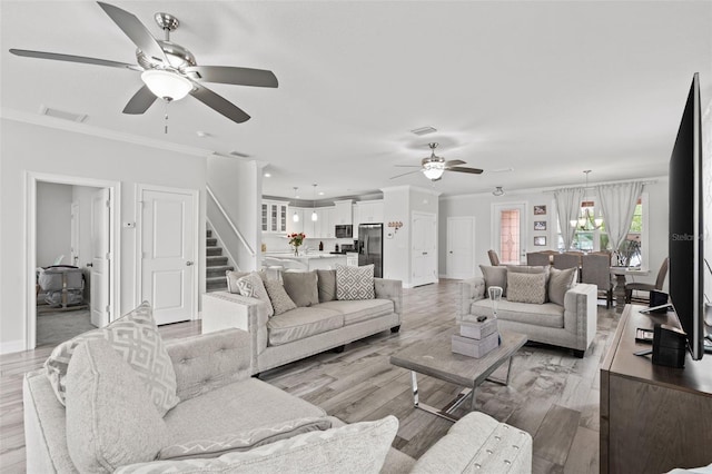 living room featuring ornamental molding, ceiling fan, and light hardwood / wood-style floors