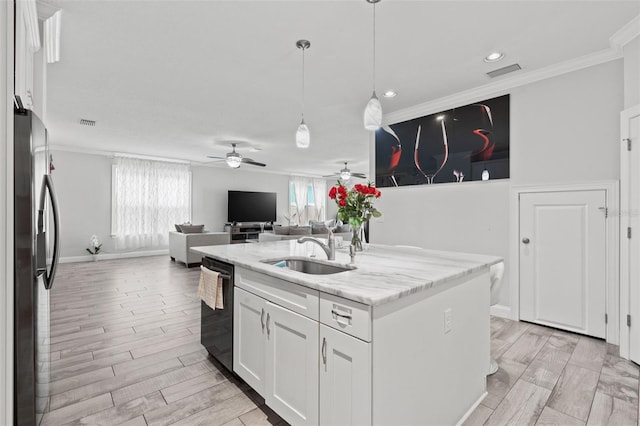 kitchen with stainless steel fridge, ceiling fan, white cabinetry, and sink