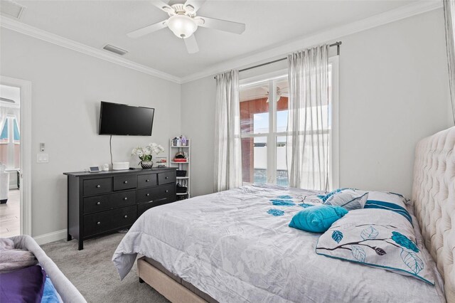 bedroom featuring crown molding, light colored carpet, and ceiling fan